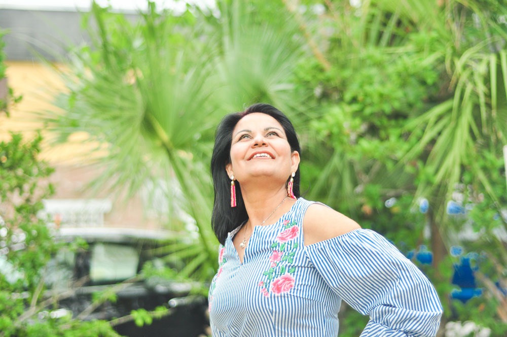 Free Photos - A Beautiful Woman With Dark Skin, Wearing A Green Dress And  Diamond Earrings. She Has A Captivating Smile And Is The Main Focus Of The  Picture. | FreePixel.com