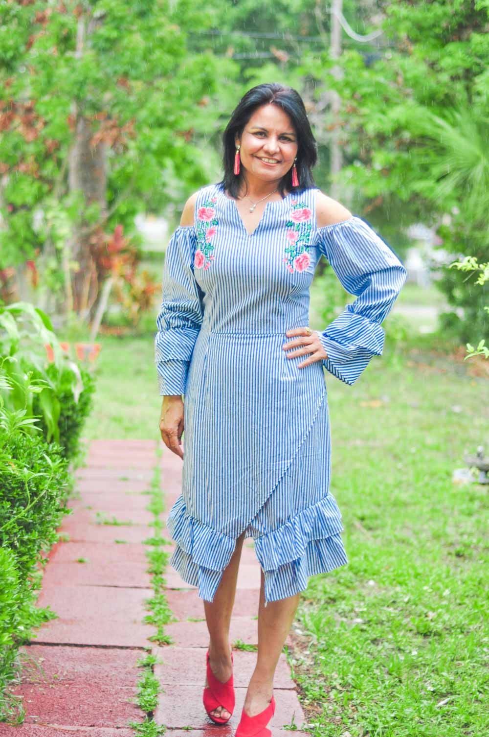 A woman wearing a blue dress and earrings photo – Free Blouse Image on  Unsplash